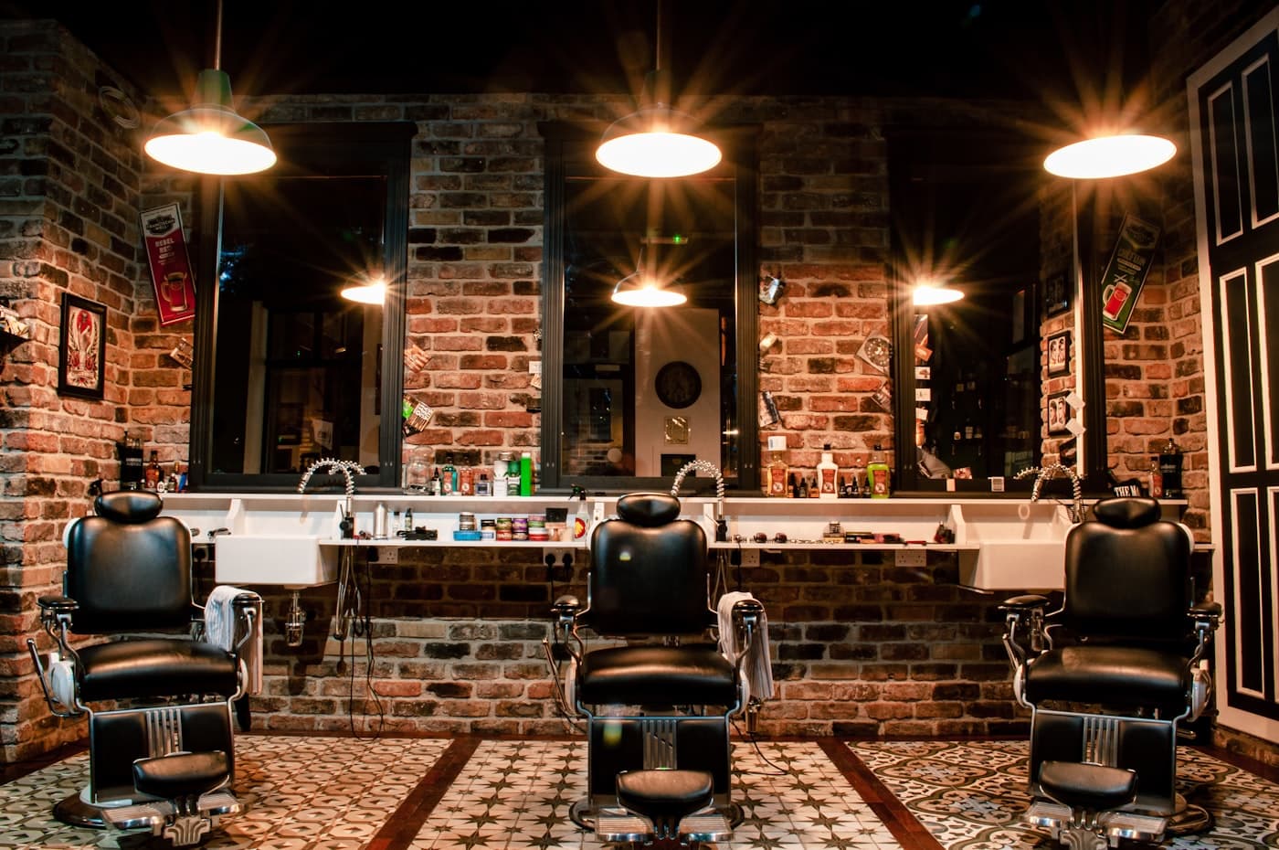 A barber trimming a customer's beard in the chair