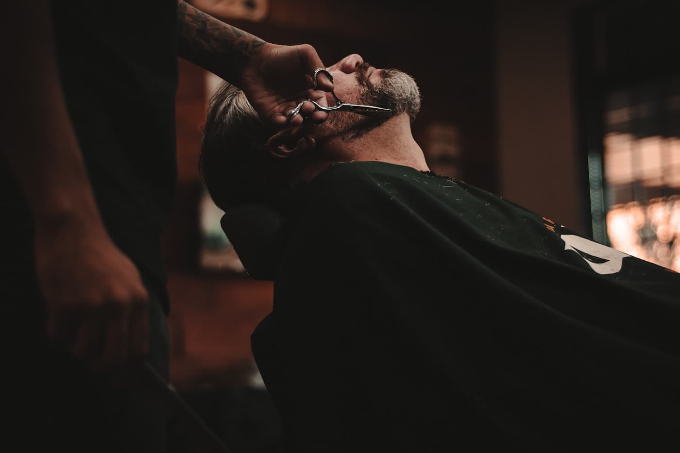 A barber at work in a busy barbershop